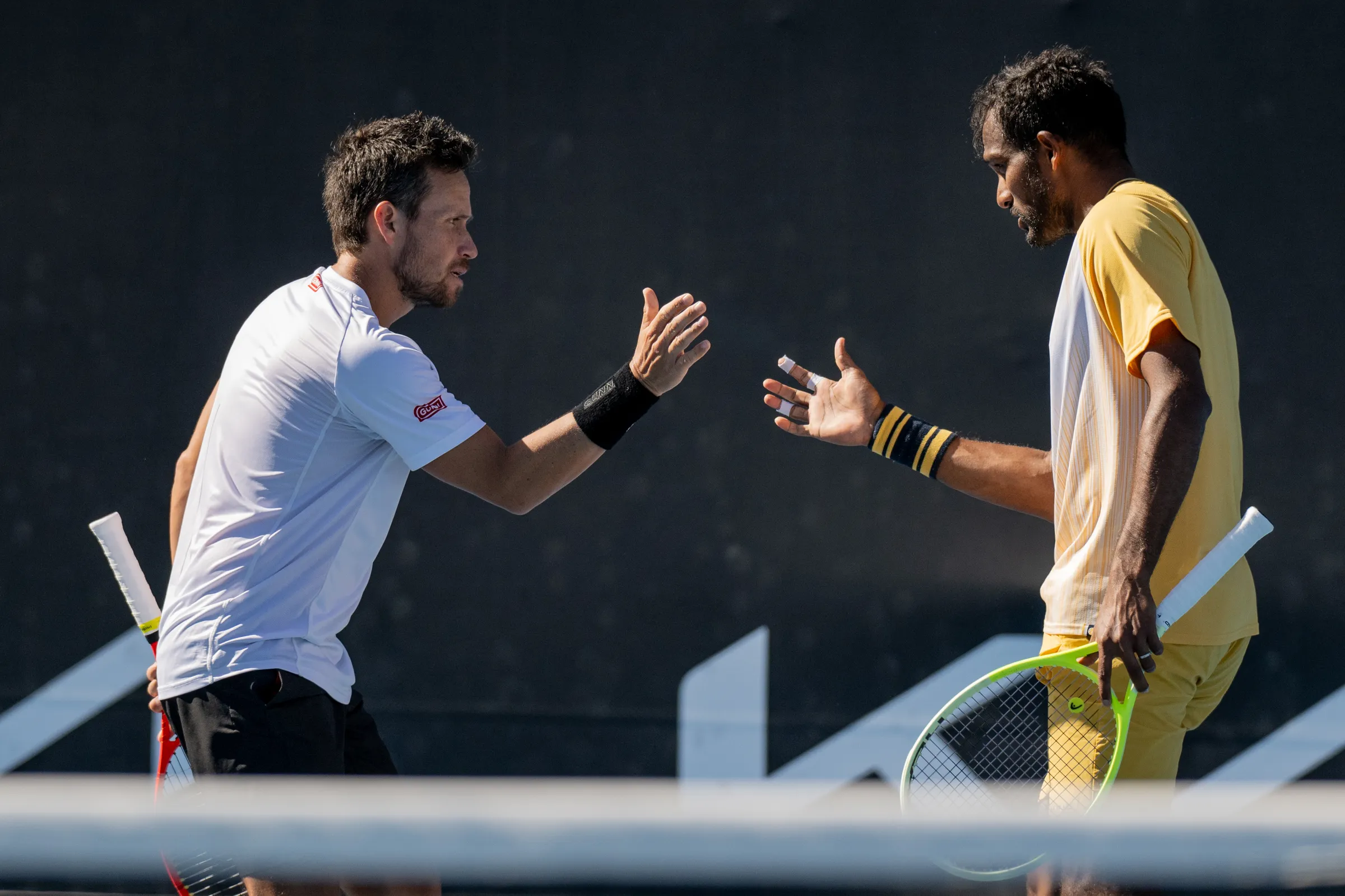Miguel high-fives his doubles partner during a match.